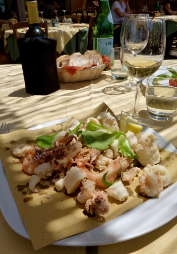 eating seafood beach tuscany 